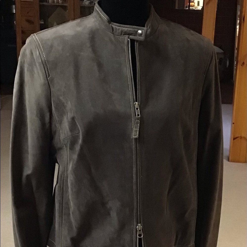 A soft suede brown jacket. It’s zips up front with a short stand up collar.